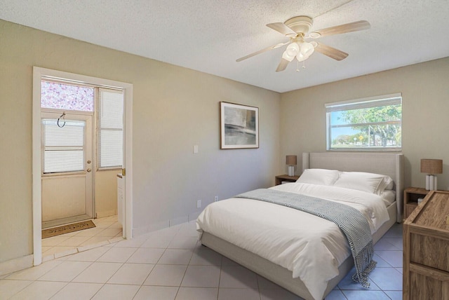 406 Flanders I, Delray Beach, FL 33484 - bedroom with light tile patterned floors, ceiling fan, and a textured ceiling