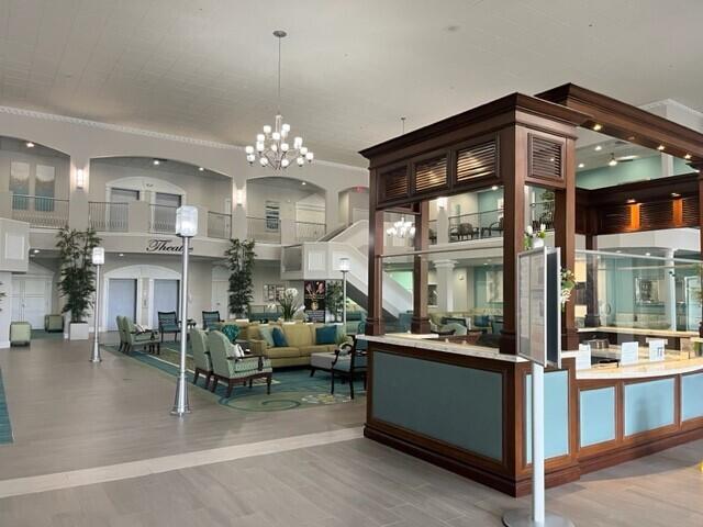 406 Flanders I, Delray Beach, FL 33484 - bar area with wood finished floors and a chandelier