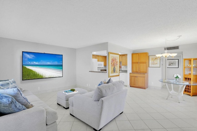 406 Flanders I, Delray Beach, FL 33484 - living area with light tile patterned floors, a chandelier, and baseboards