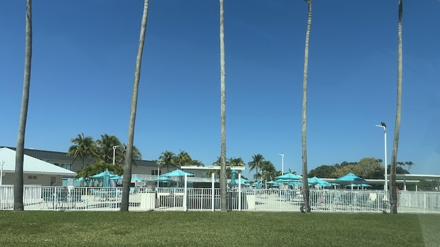 view of home's community featuring fence and a lawn