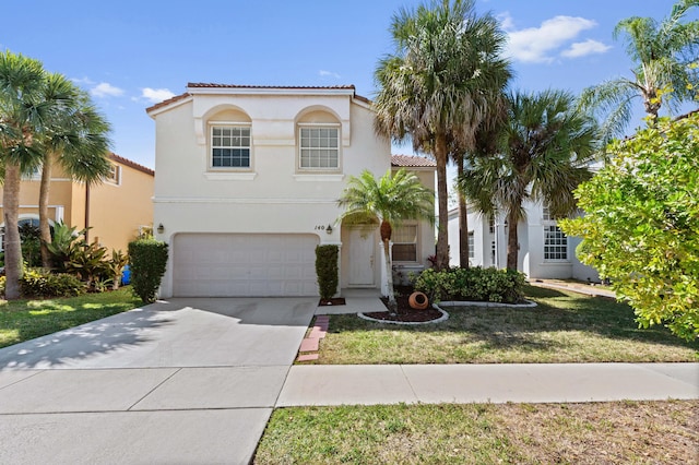 mediterranean / spanish home featuring stucco siding, a front lawn, driveway, a tile roof, and a garage