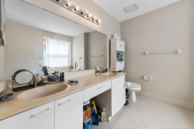 full bath with double vanity, tile patterned flooring, toilet, and a sink