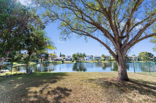 view of water feature with fence and a residential view