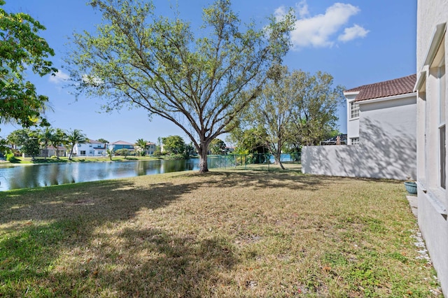 view of yard featuring fence and a water view