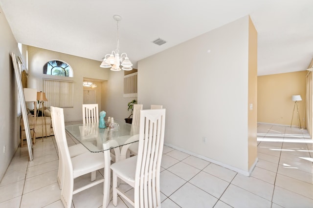 dining area with light tile patterned floors, visible vents, baseboards, and an inviting chandelier