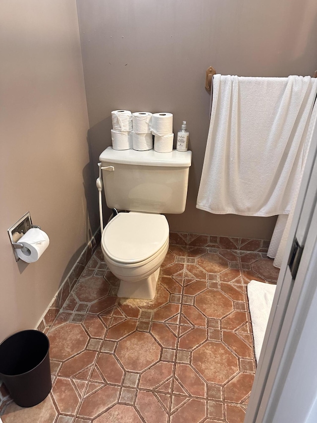 bathroom featuring tile patterned floors, toilet, and baseboards