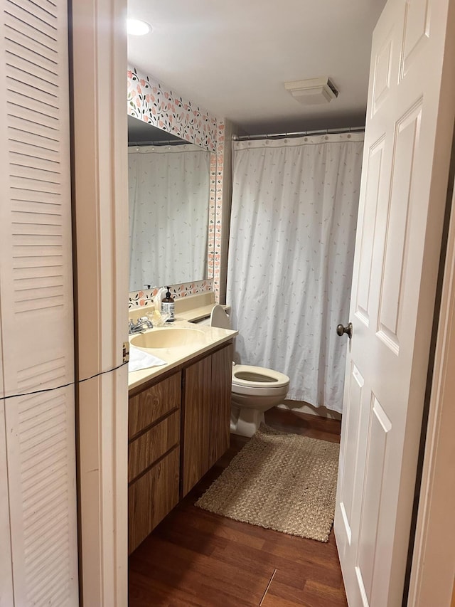 full bathroom featuring vanity, toilet, wood finished floors, and visible vents