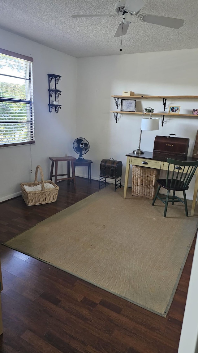 interior space featuring wood finished floors, ceiling fan, and a textured ceiling