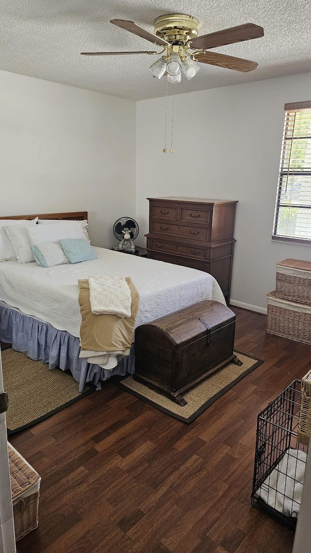 bedroom with baseboards, a ceiling fan, wood finished floors, and a textured ceiling