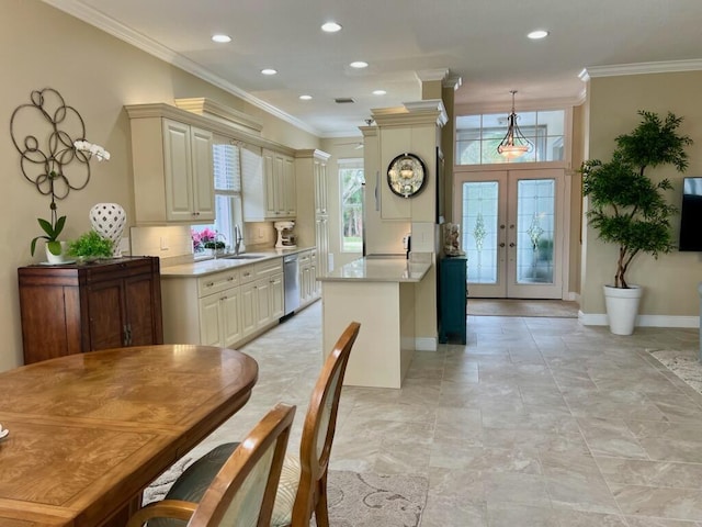 kitchen with stainless steel dishwasher, light countertops, french doors, and ornamental molding