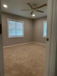 carpeted empty room with recessed lighting, a ceiling fan, and baseboards