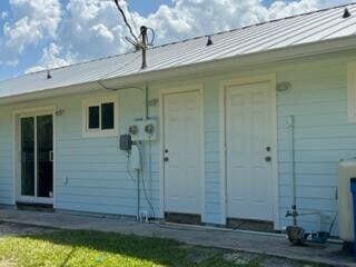 entrance to property featuring a standing seam roof and metal roof