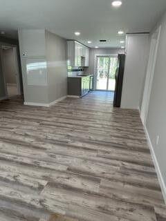 kitchen with recessed lighting, wood finished floors, and baseboards