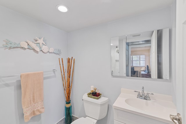 bathroom featuring toilet and vanity