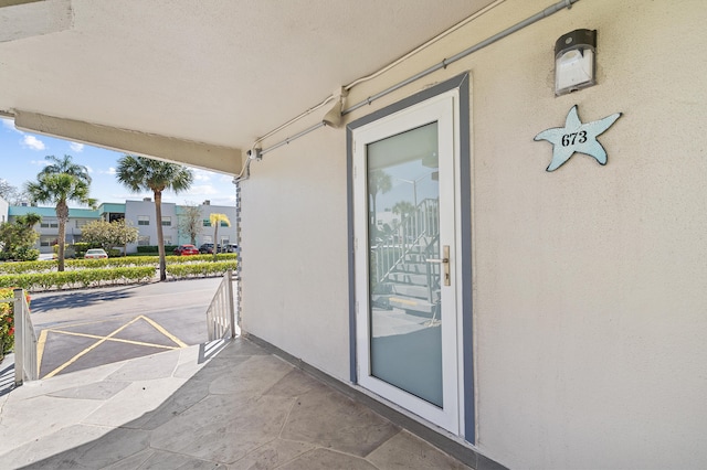 entrance to property featuring stucco siding