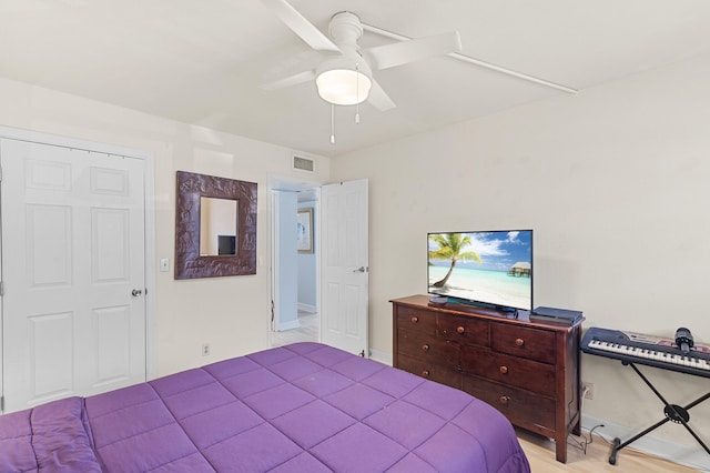 bedroom with visible vents, baseboards, and ceiling fan