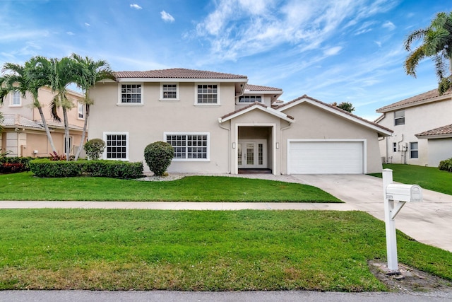 view of front of home featuring stucco siding, driveway, a front lawn, and a garage