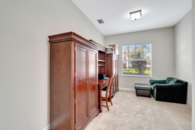 office with baseboards, visible vents, light carpet, and vaulted ceiling