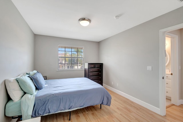 bedroom featuring baseboards and light wood finished floors