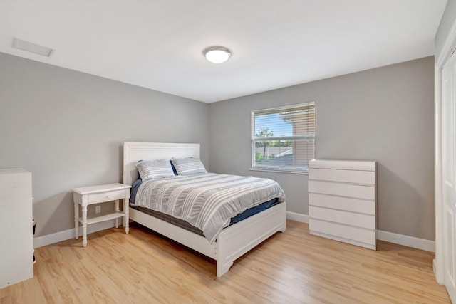 bedroom featuring baseboards and light wood-style flooring