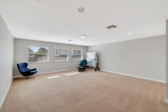 unfurnished room with baseboards, visible vents, and light colored carpet
