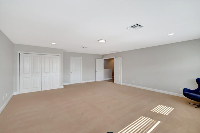 unfurnished room with baseboards, carpet floors, and visible vents