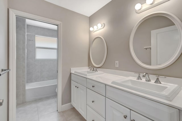 full bath with tile patterned flooring, a sink, baseboards, and double vanity