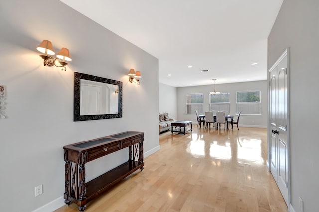 corridor with recessed lighting, baseboards, light wood-type flooring, and visible vents