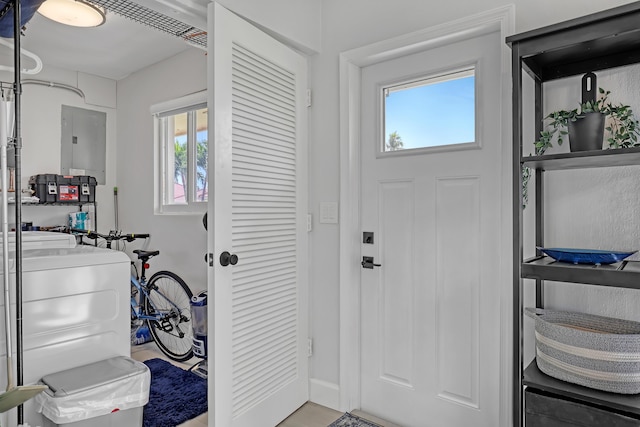 entryway with washer / dryer, electric panel, and a wealth of natural light