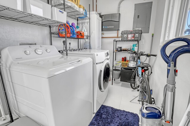 laundry room with electric panel, tile patterned flooring, laundry area, and washer and dryer