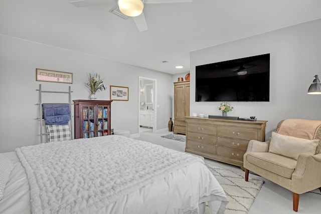 bedroom with ensuite bath, a ceiling fan, and baseboards
