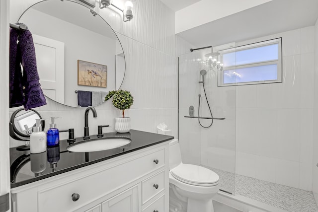 full bathroom with vanity, toilet, a walk in shower, and tasteful backsplash