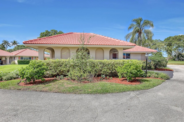 mediterranean / spanish-style home featuring stucco siding and a tile roof