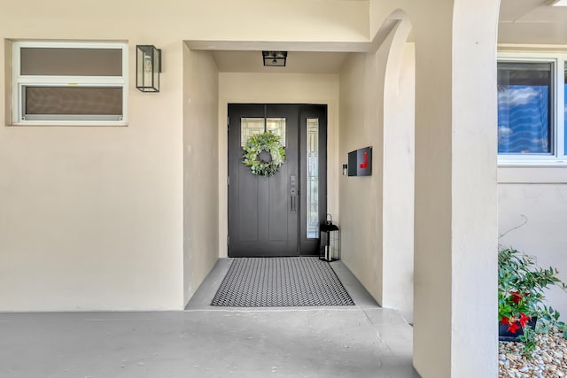 entrance to property with stucco siding