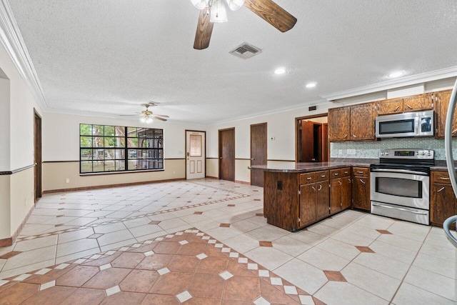 kitchen featuring visible vents, dark countertops, appliances with stainless steel finishes, a peninsula, and crown molding