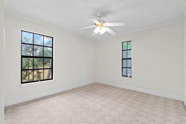 spare room with crown molding, light colored carpet, and baseboards