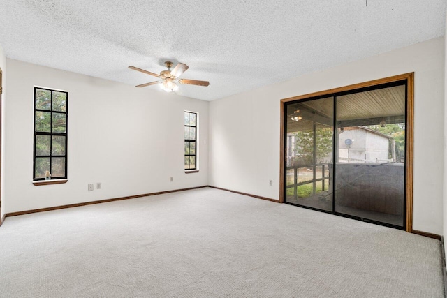 unfurnished room with carpet, a healthy amount of sunlight, and baseboards