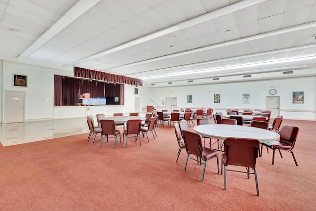 dining area featuring visible vents, baseboards, and light colored carpet