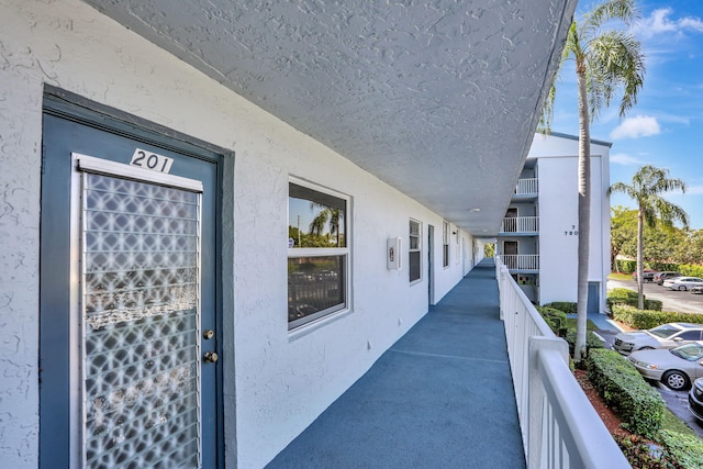 doorway to property with stucco siding and a balcony