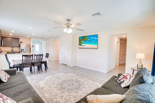 living area featuring visible vents, recessed lighting, light wood-type flooring, and ceiling fan