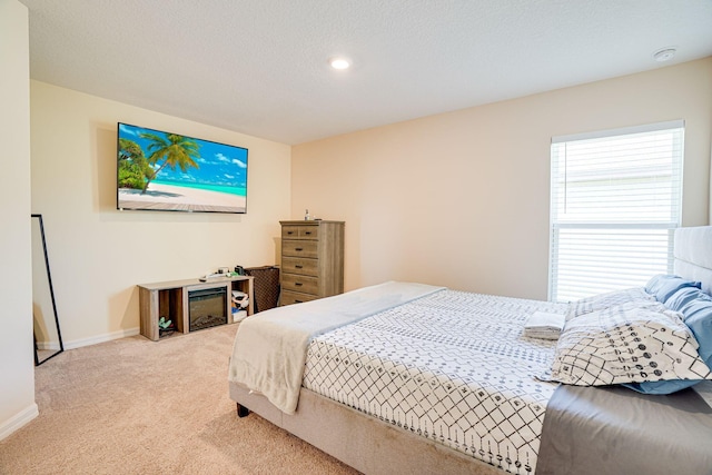 bedroom with carpet flooring, baseboards, and a textured ceiling