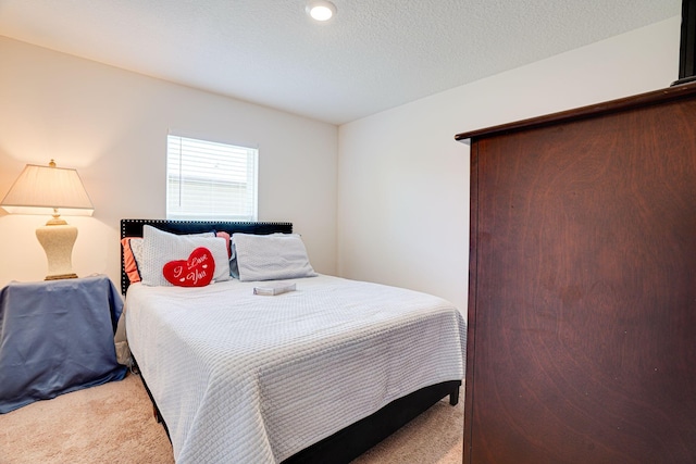 carpeted bedroom with a textured ceiling