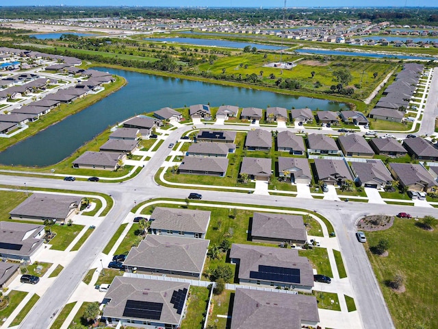 drone / aerial view featuring a residential view and a water view