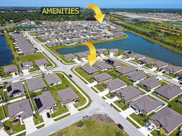 bird's eye view featuring a residential view and a water view