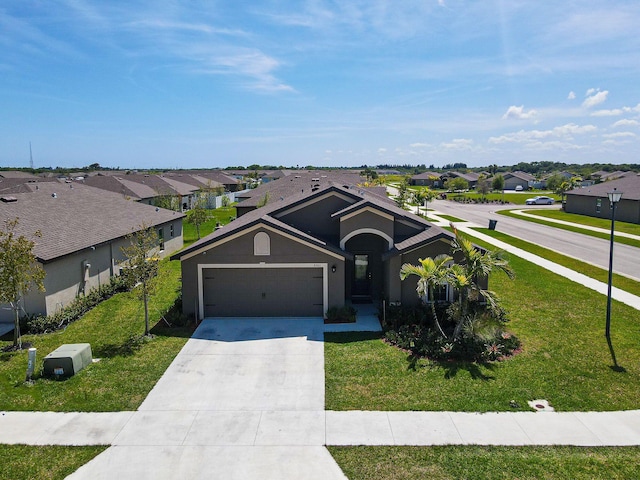 single story home featuring a residential view, concrete driveway, a front yard, stucco siding, and a garage