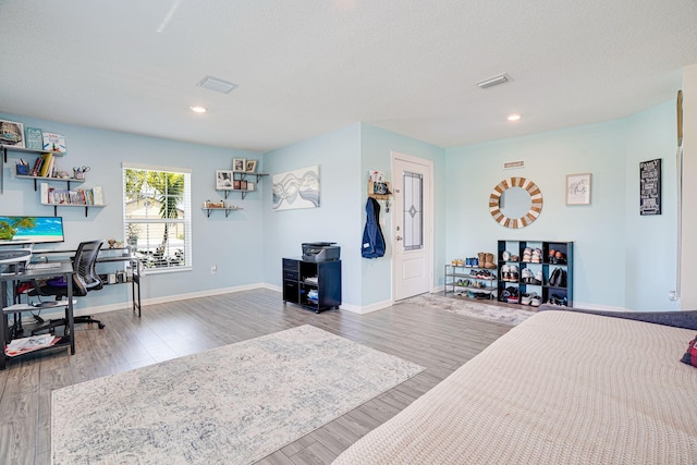 bedroom with visible vents, a textured ceiling, wood finished floors, recessed lighting, and baseboards