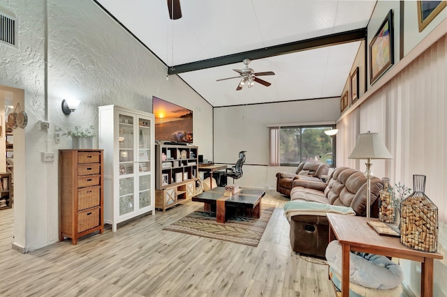 living room with beam ceiling, light wood-style flooring, high vaulted ceiling, and ceiling fan