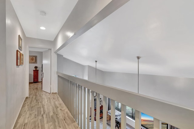 hallway with baseboards and wood finished floors