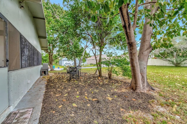 view of yard with an outbuilding and fence