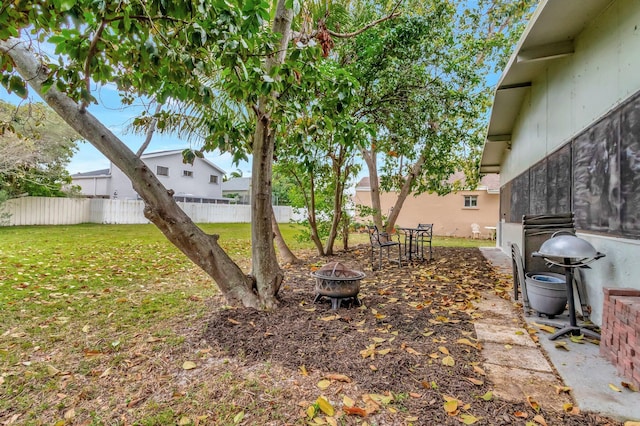 view of yard featuring fence and an outdoor fire pit